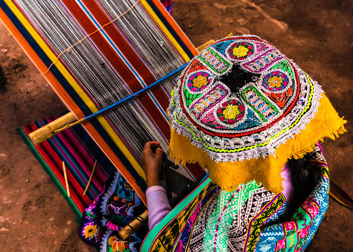 andean woman weaving in peru