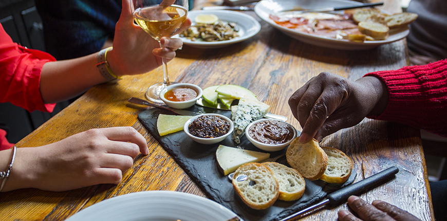 people sharing an appetizer at amada.