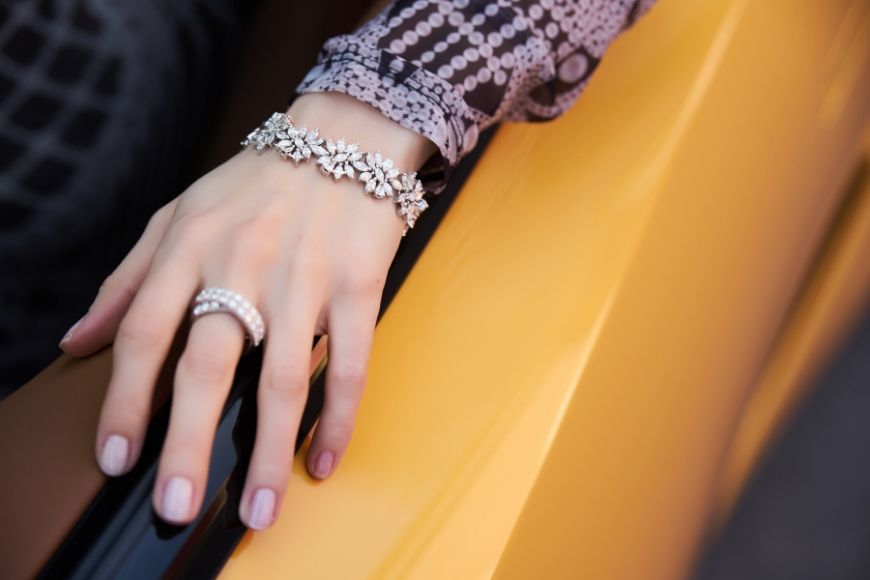 diamond ring and bracelet on yellow car.