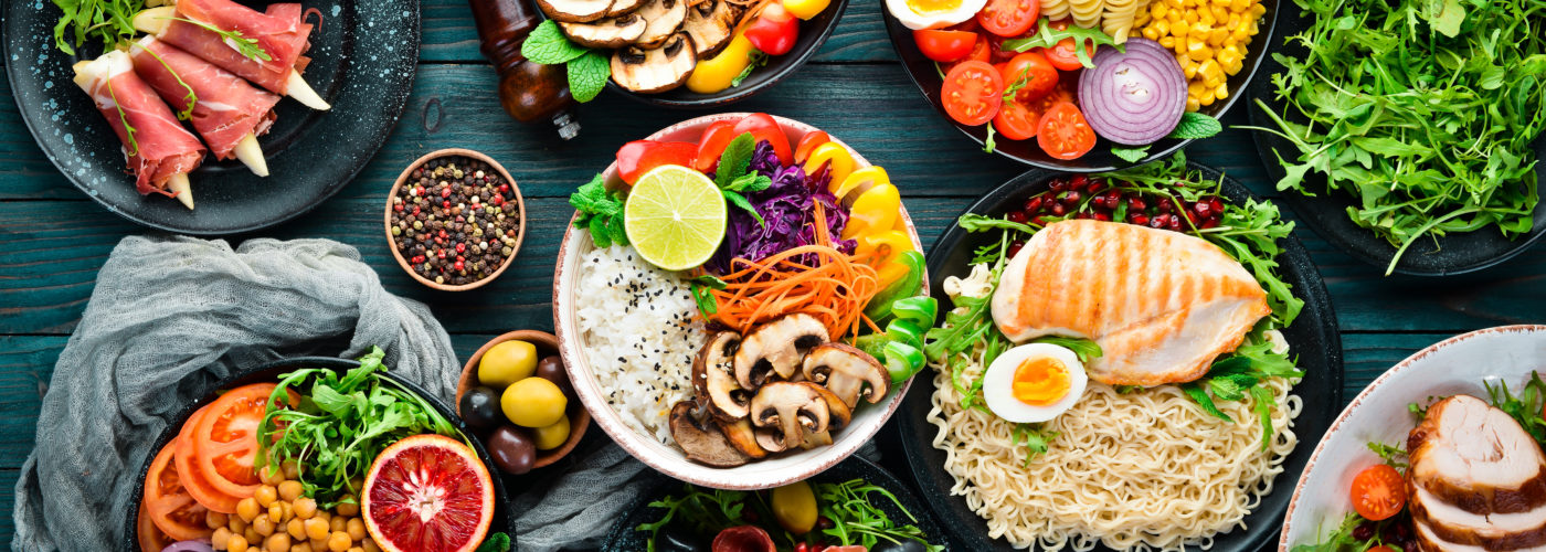 Assortment of healthy foods laid out on black wooden table