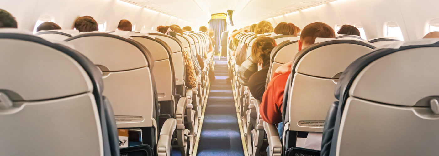 View of a full plane cabin from the back