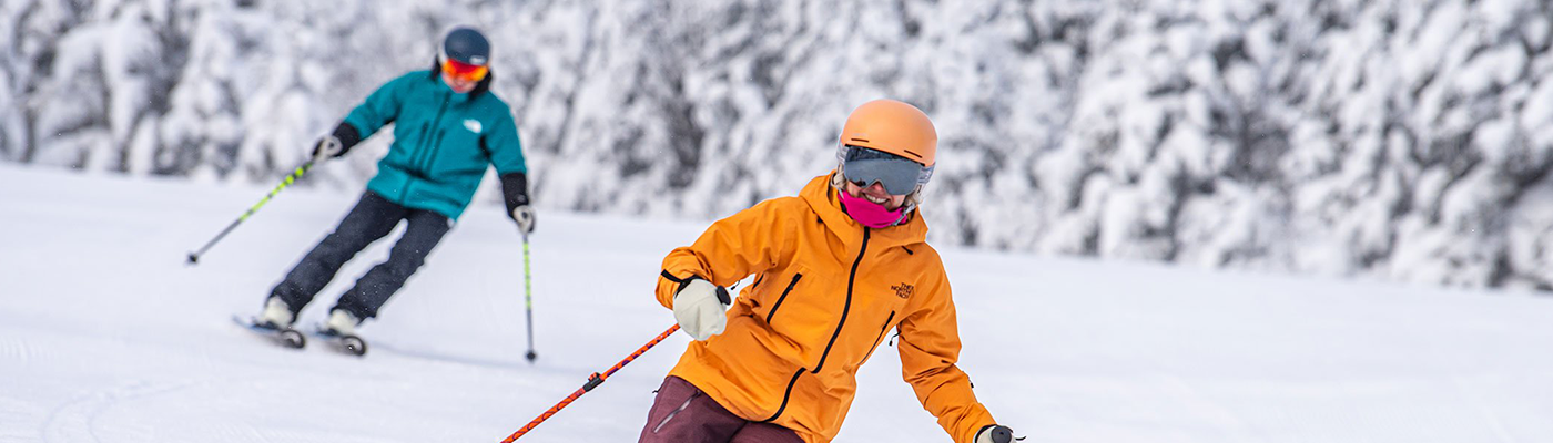 Two people skiing down Stratton Mountain