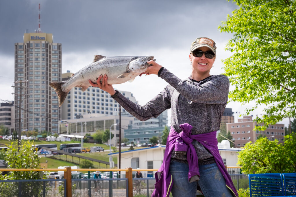 Woman fishing in Slam'n Salmon Derby at Ship Creek in Anchorage, Alaska