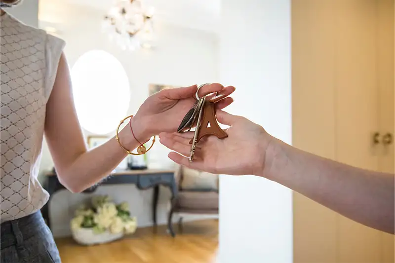 Person being handed the keys for a vacation rental