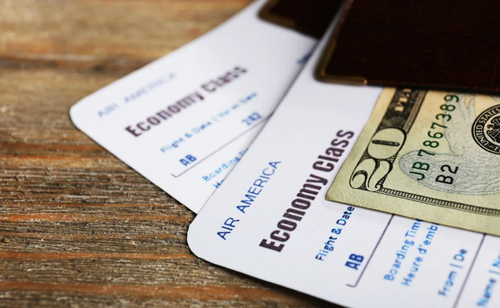 Flight tickets and documents on wooden table, close-up