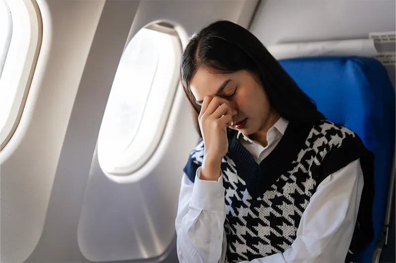 Person looking distressed on airplane