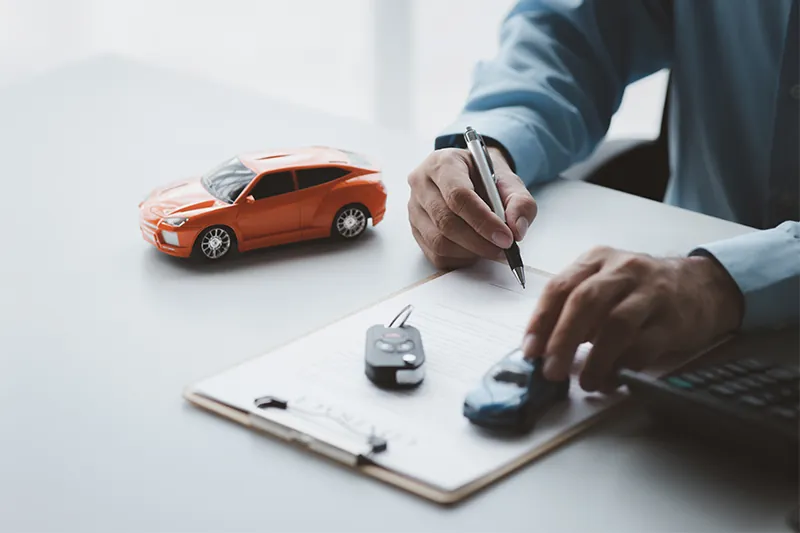 Person signing car rental insurance