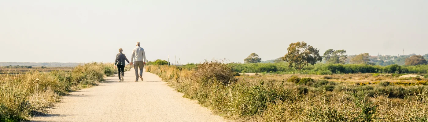 Elderly couple in love walking on a dust road, Portugal